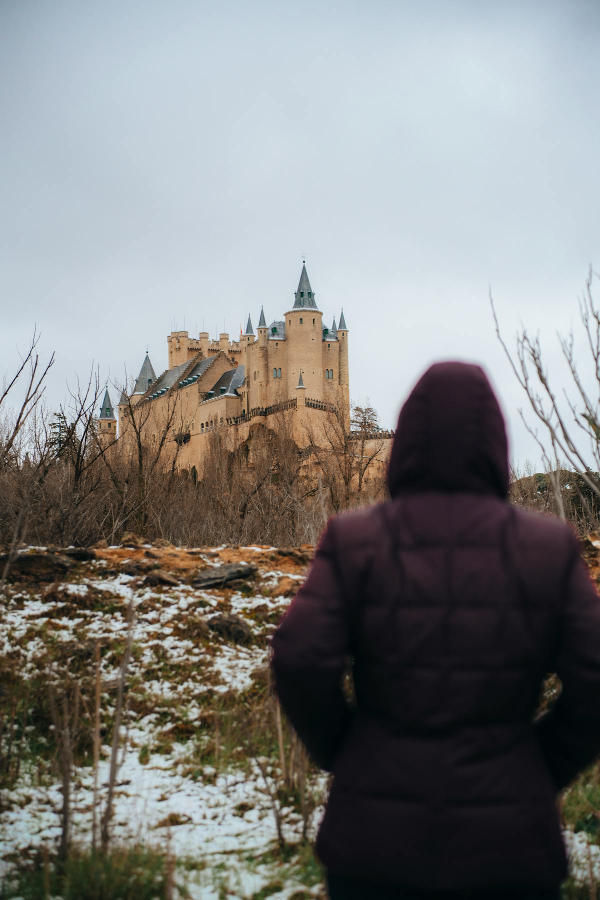 The Alcazar of Segovia from a distance showing its dramatic position on the cliff edge