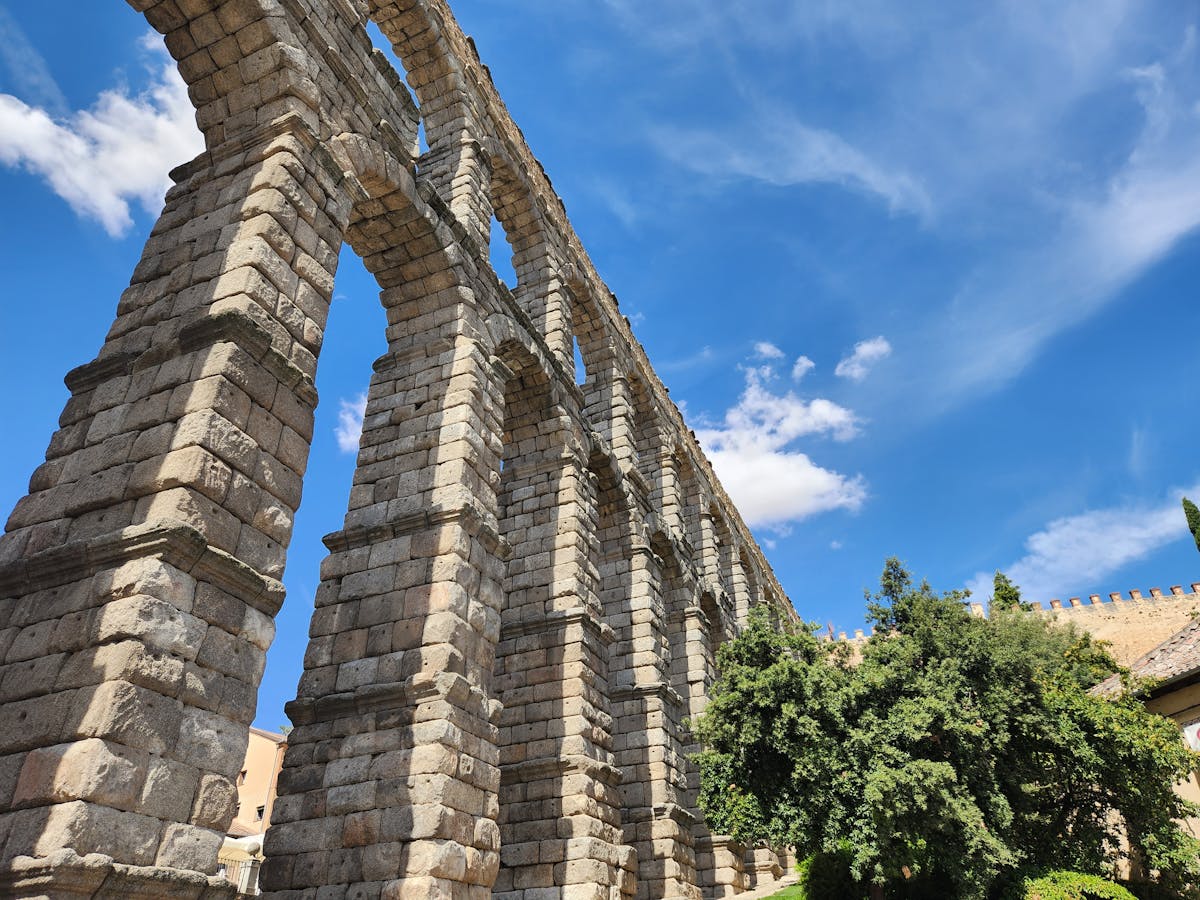 The Roman aqueduct of Segovia stretching across the city center with its massive stone arches