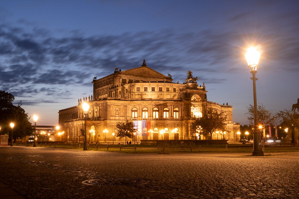 The Semperoper beautifully illuminated at night with warm golden lights