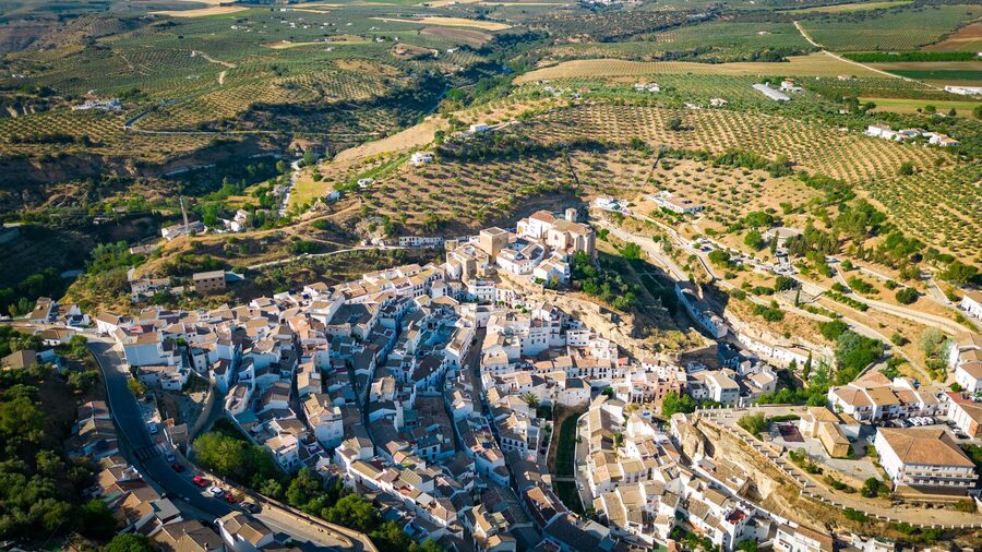 Setenil de las Bodegas from above showing cliff houses and green valley
