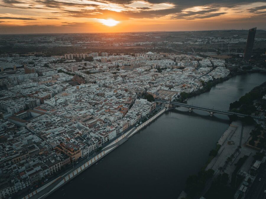Aerial photograph of Seville Spain at sunset showing the Guadalquivir River and city skyline
