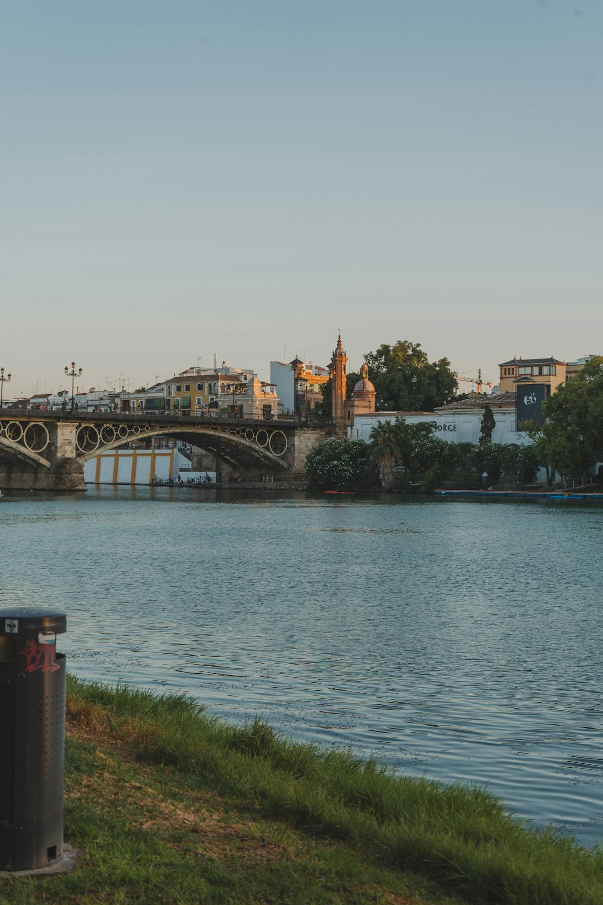 Puente de Isabel II over the Guadalquivir River in Seville during sunset with golden light