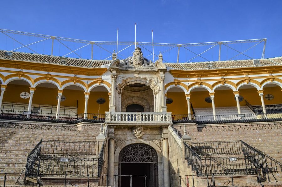 The historic Seville bullring Plaza de Toros bathed in sunlight