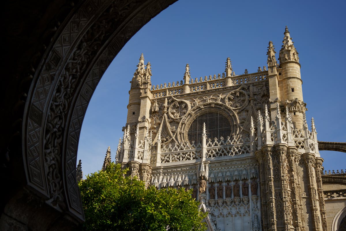 The Seville Cathedral and Giralda tower viewed from a nearby street in the old quarter