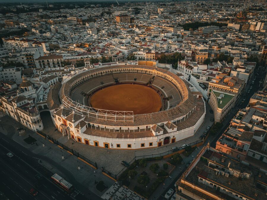The Maestranza bullring set against the broader Seville urban landscape from drone perspective