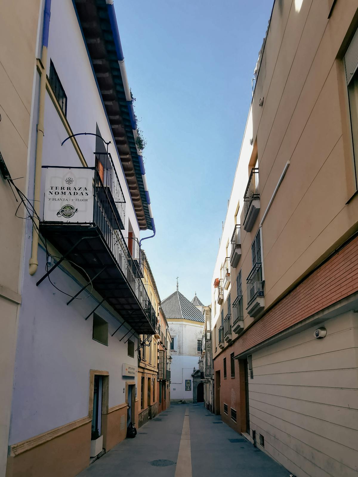 Narrow street in the old quarter of Seville Spain with traditional Andalusian buildings