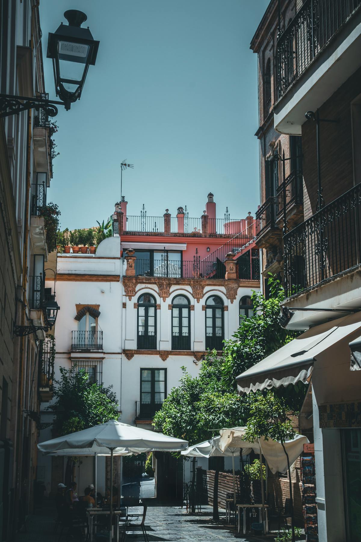 Outdoor cafes and dining along a historic street in Seville