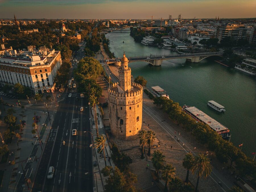 Torre del Oro medieval tower on the Guadalquivir River at sunset in Seville