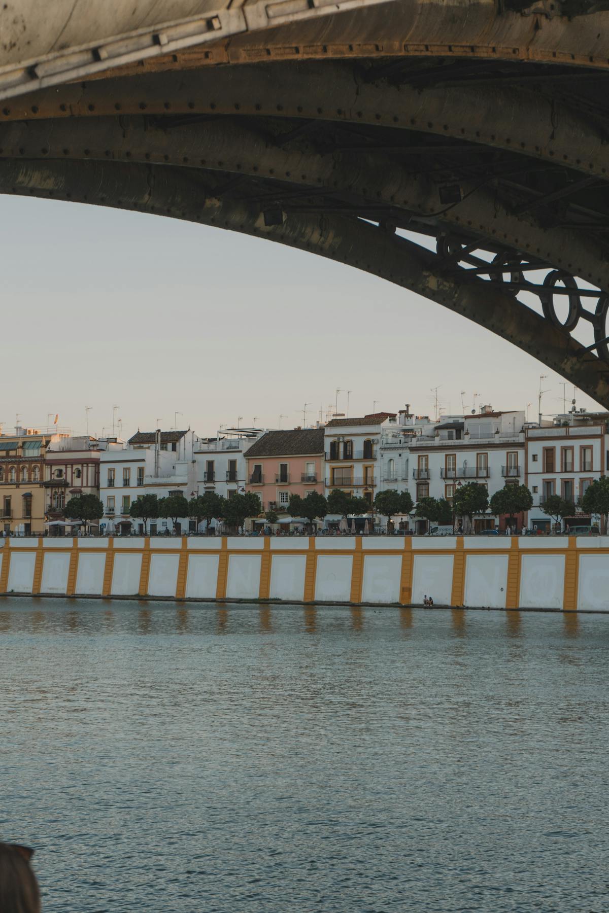 Triana district seen from under the Isabel II bridge at sunset in Seville