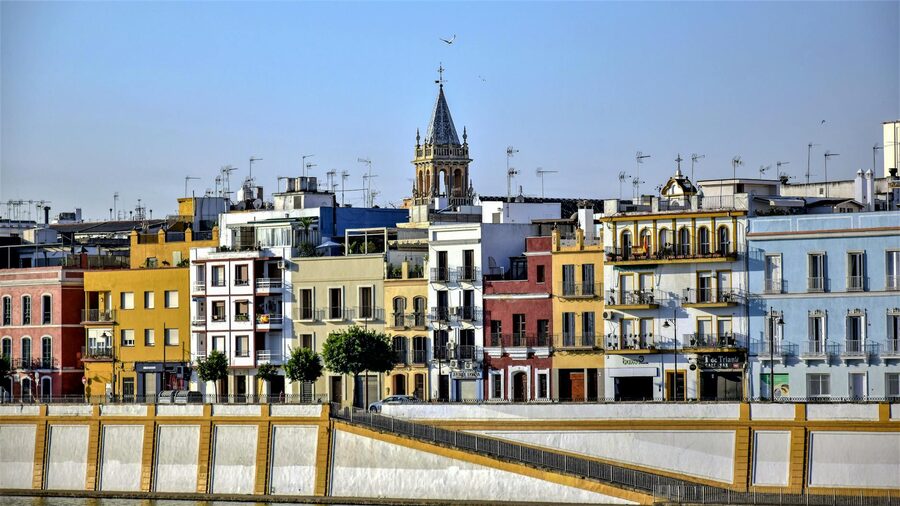 Colorful building facades along the river in Seville Triana neighborhood