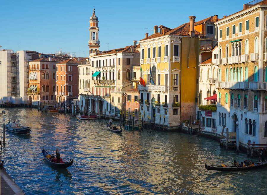 Gondolas navigating a historic Venetian canal