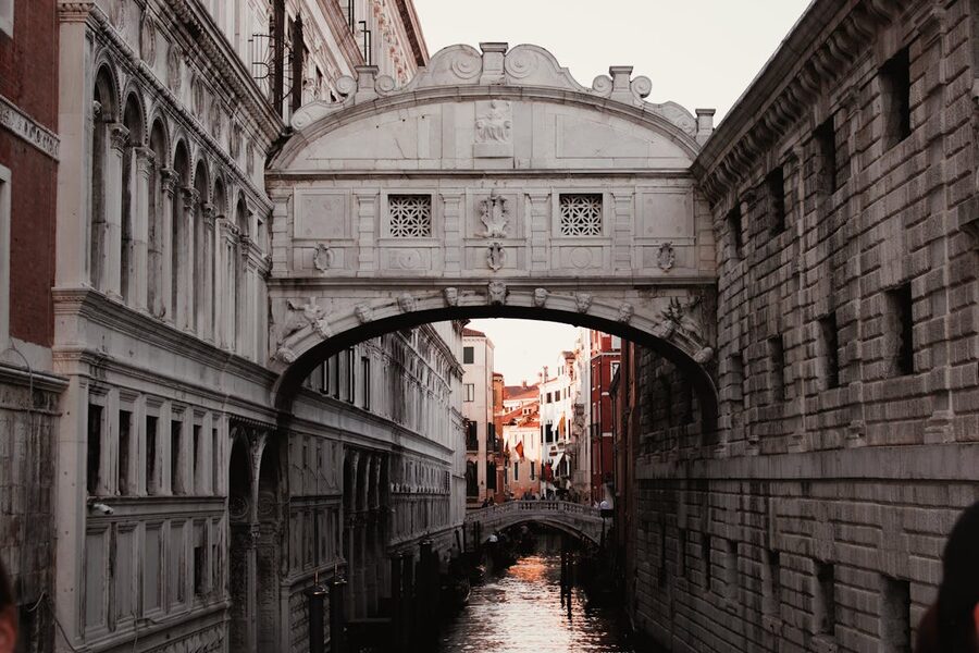 Bridge of Sighs over a Venice canal at sunset