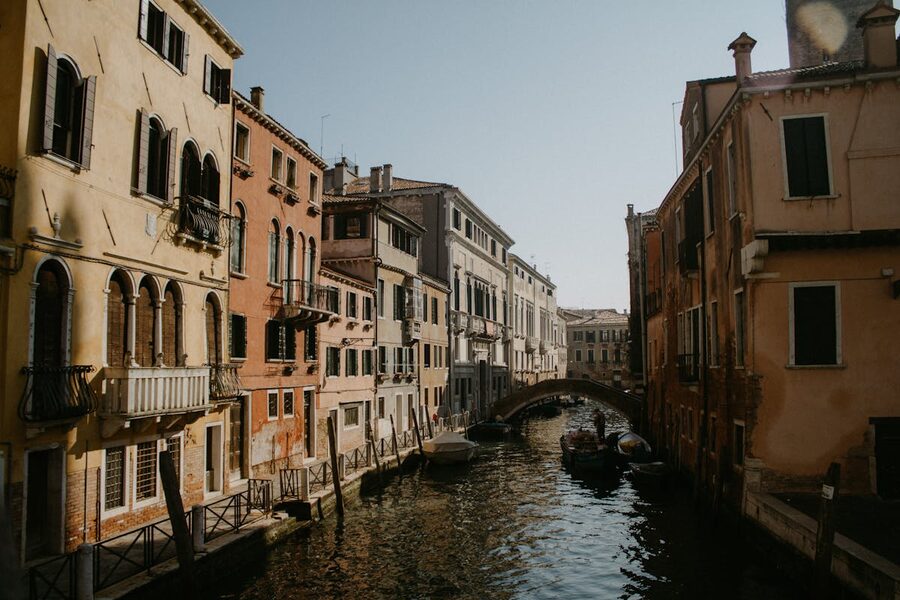 Narrow Venice canal with historic buildings on a sunny day