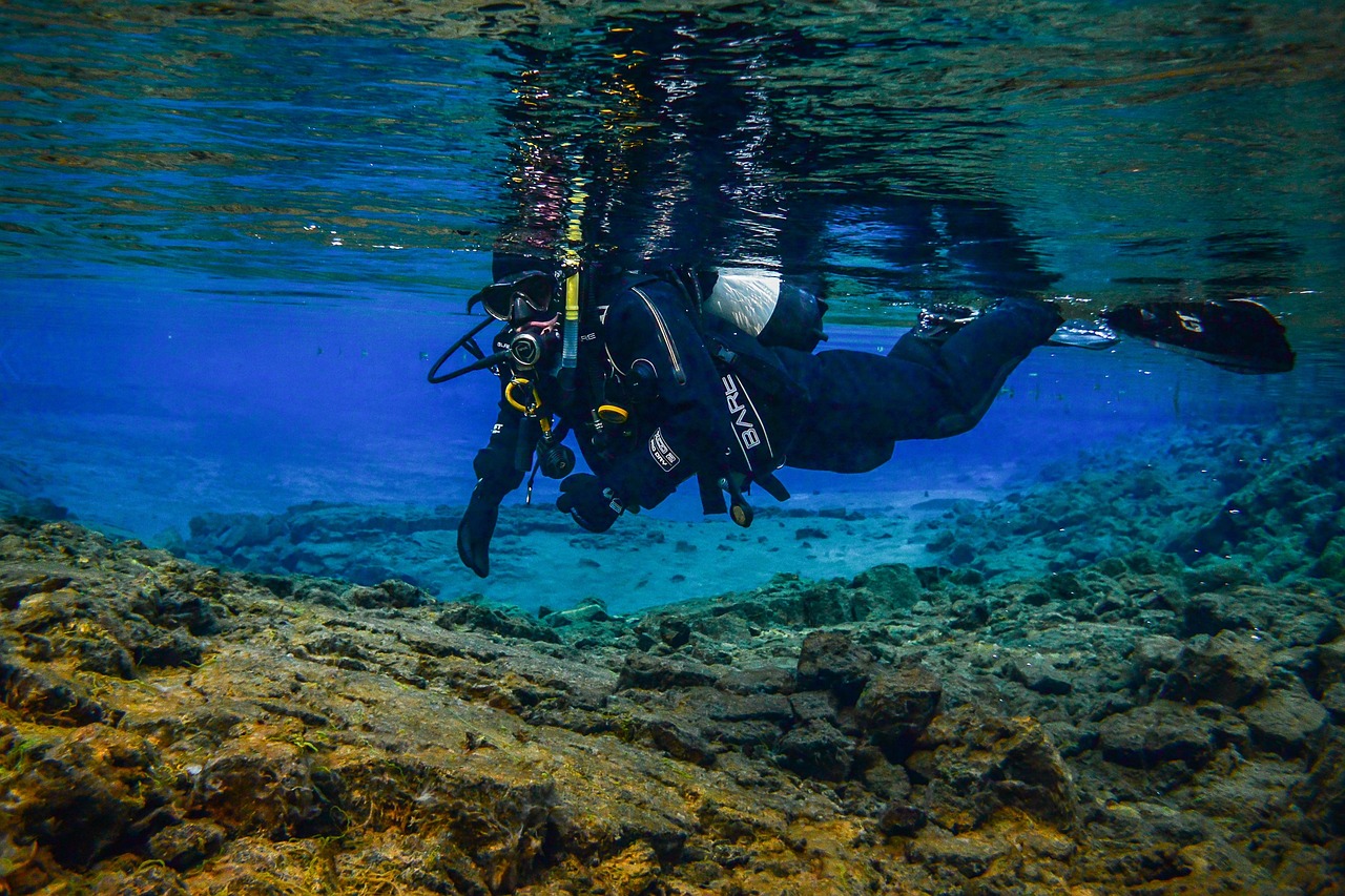 Underwater rock formations and clear blue glacial water in the Silfra fissure tectonic plate gap