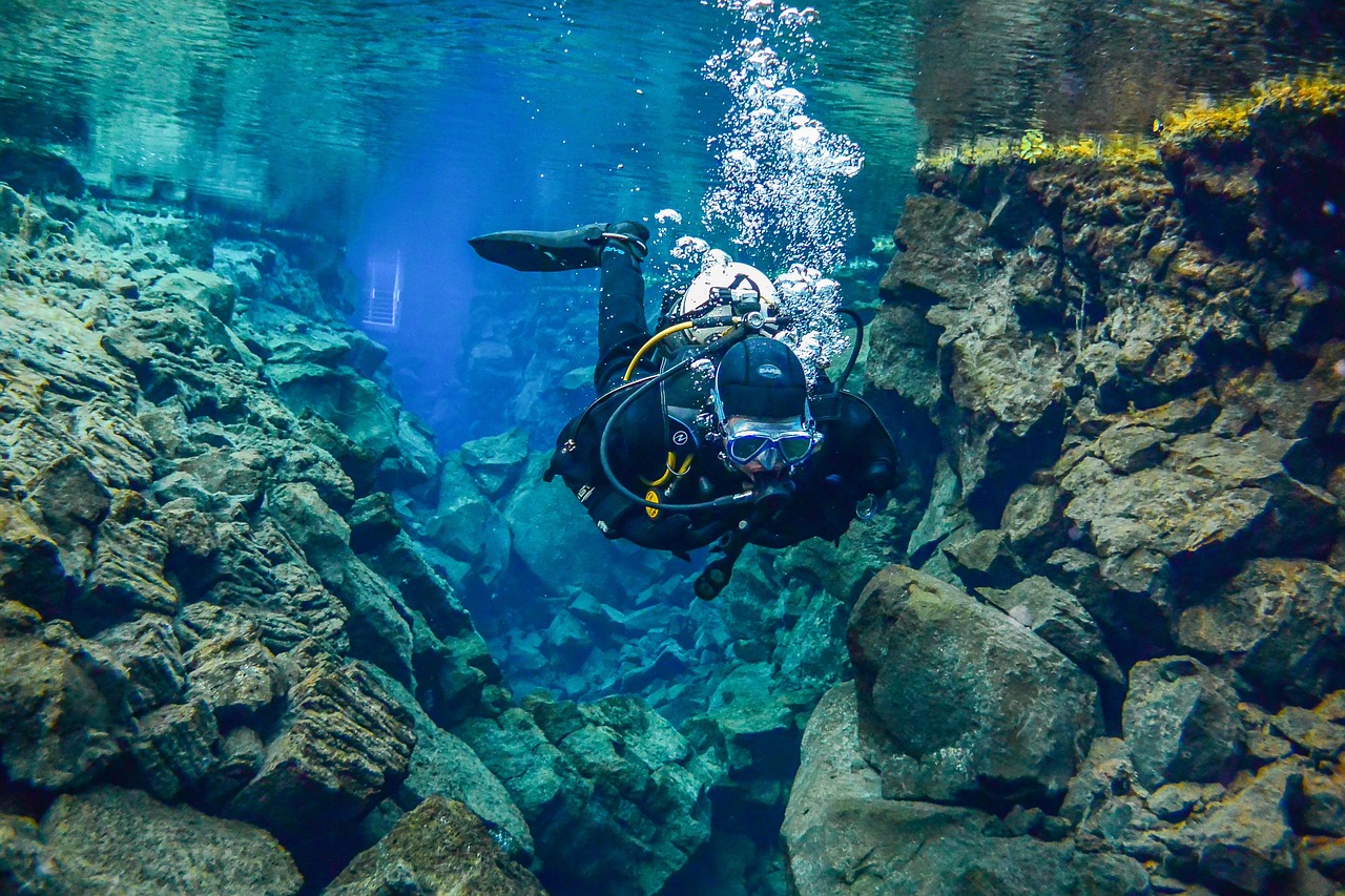 Underwater view of the crystal clear blue waters in Silfra fissure showing rock walls and turquoise water