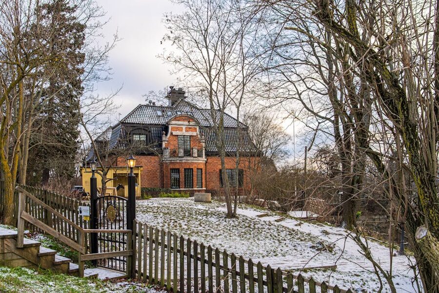 Skansen red brick house in snowy winter garden Stockholm