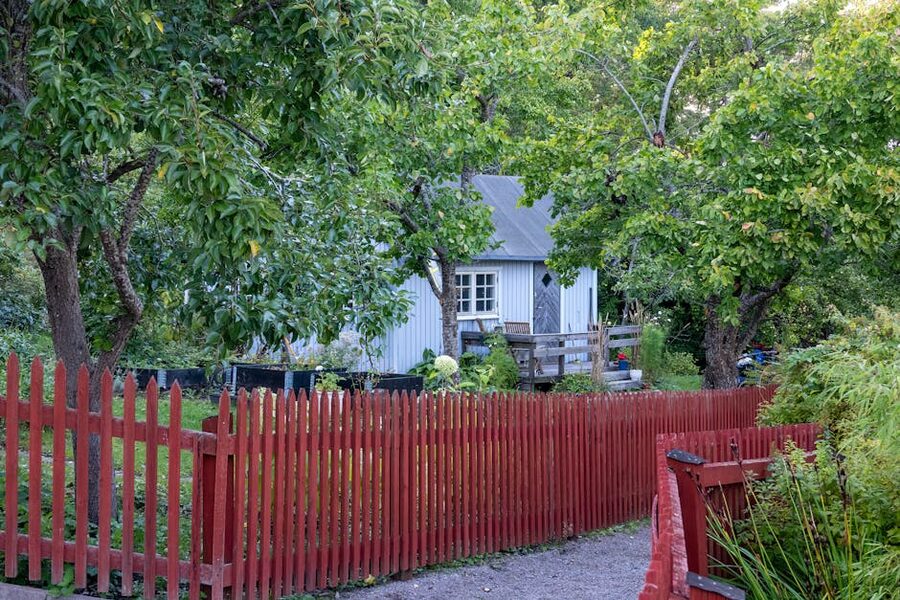 Scandinavian garden at Skansen with red picket fence and trees