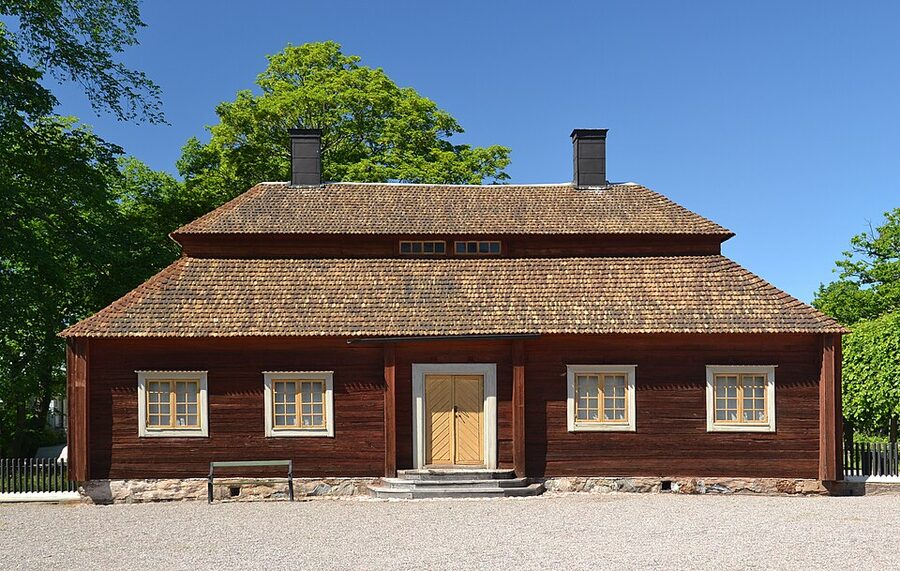Skansen Stockholm wide view of historic wooden buildings on hilltop