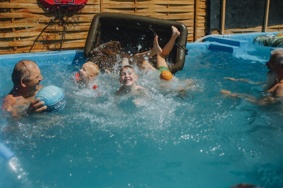 Family splashing in pool on a sunny day