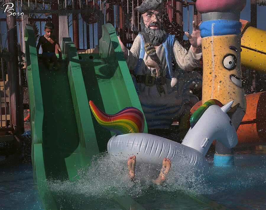 Water slide rider on a float tube