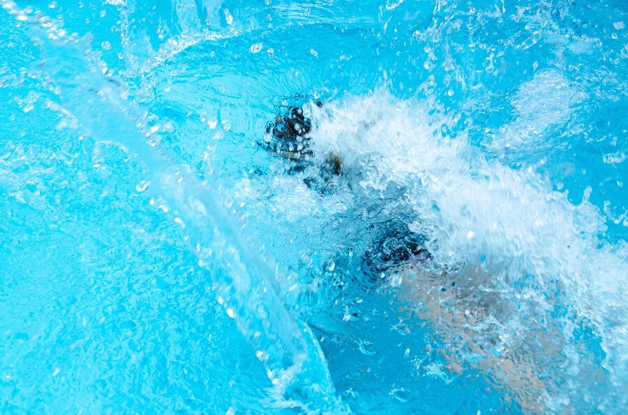 Big splash leaping into the pool