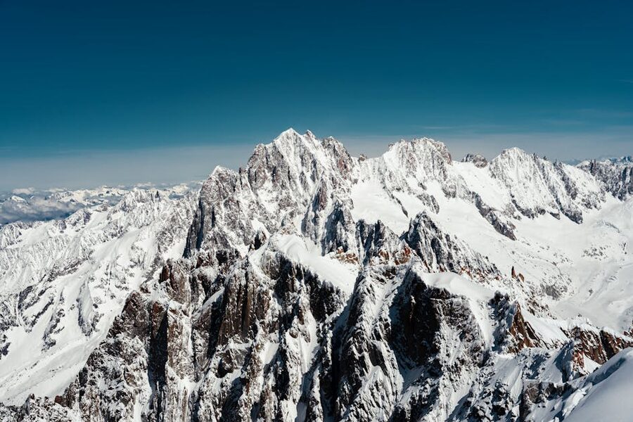 Snow-covered mountains under clear blue sky