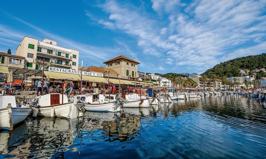 Soller port harbour with boats and tram tracks along the waterfront