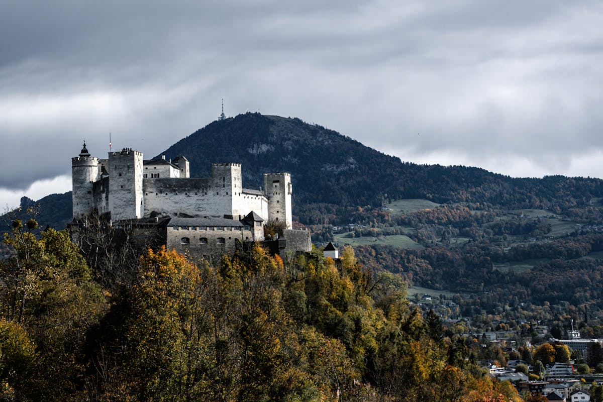 Hohensalzburg Castle surrounded by autumn foliage in Salzburg Austria