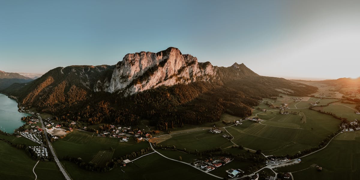 Aerial view of Mondsee lake and surrounding mountains during sunset in Upper Austria