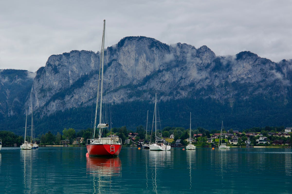 Sailboats anchored on Mondsee Lake with mountain backdrop in Austria