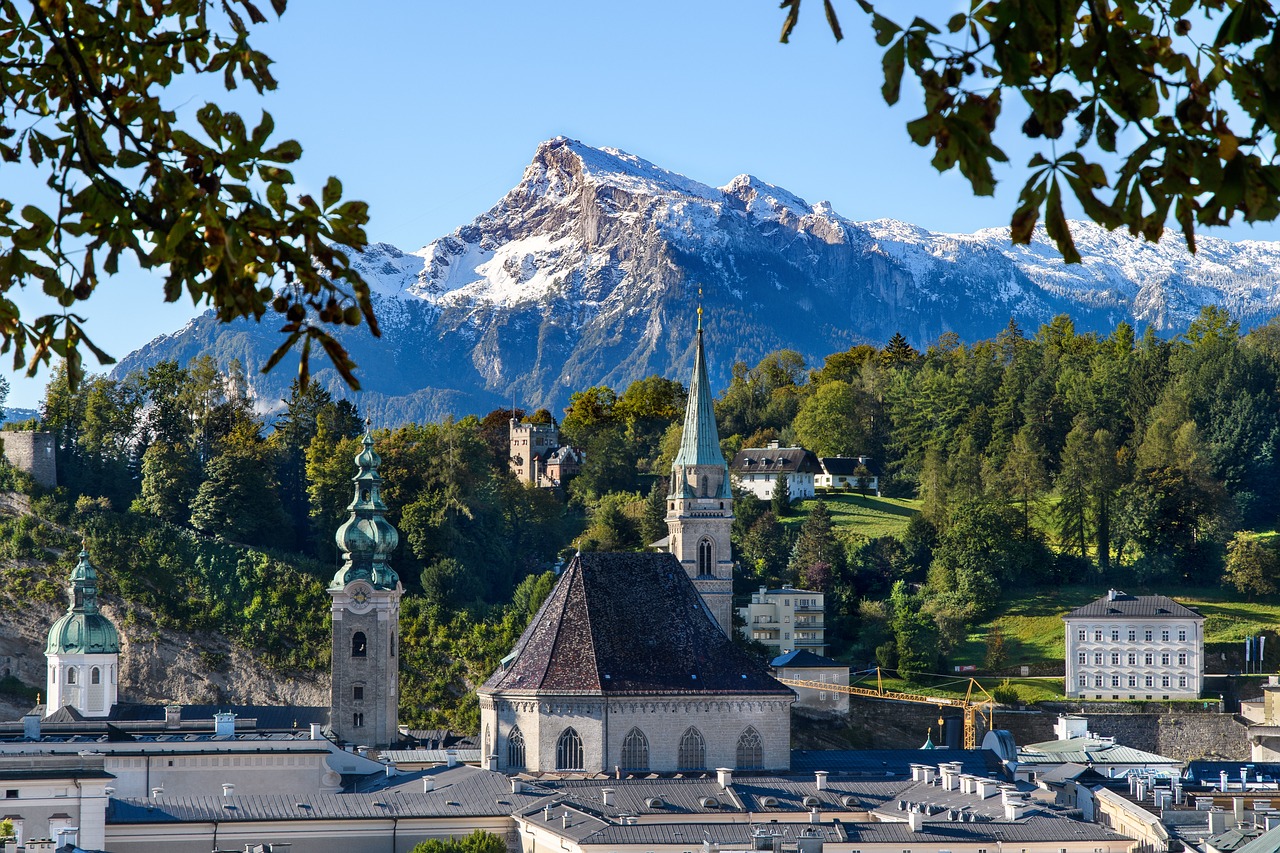 Buildings in Salzburg old town with mountain range in the background