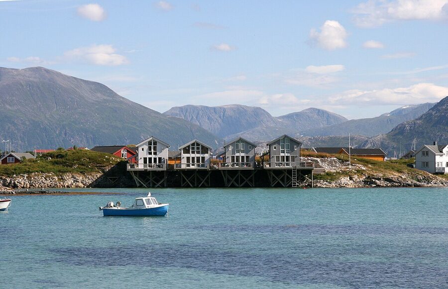 Sommaroy Norway fishing boats and red boathouses in the harbour