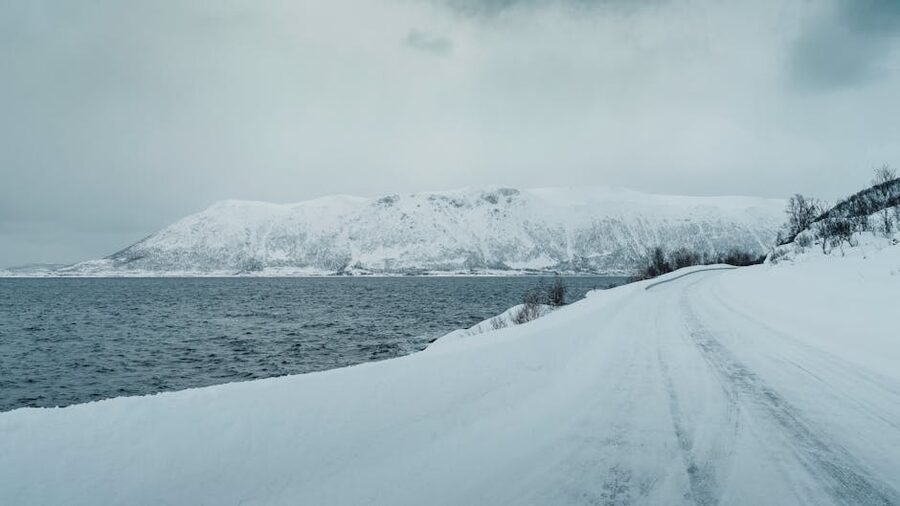Snowy coastal road on the way to Sommaroy from Tromso Norway