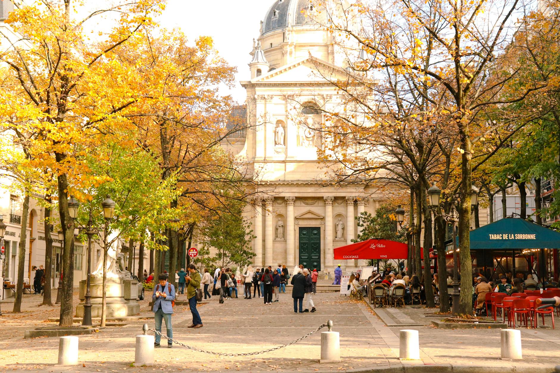 Autumn scene at the Sorbonne in Paris with people enjoying fall foliage