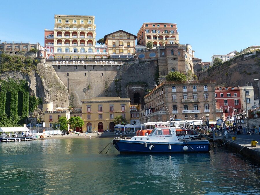 Sorrento harbor and cliffs viewed from the sea with boats in the foreground