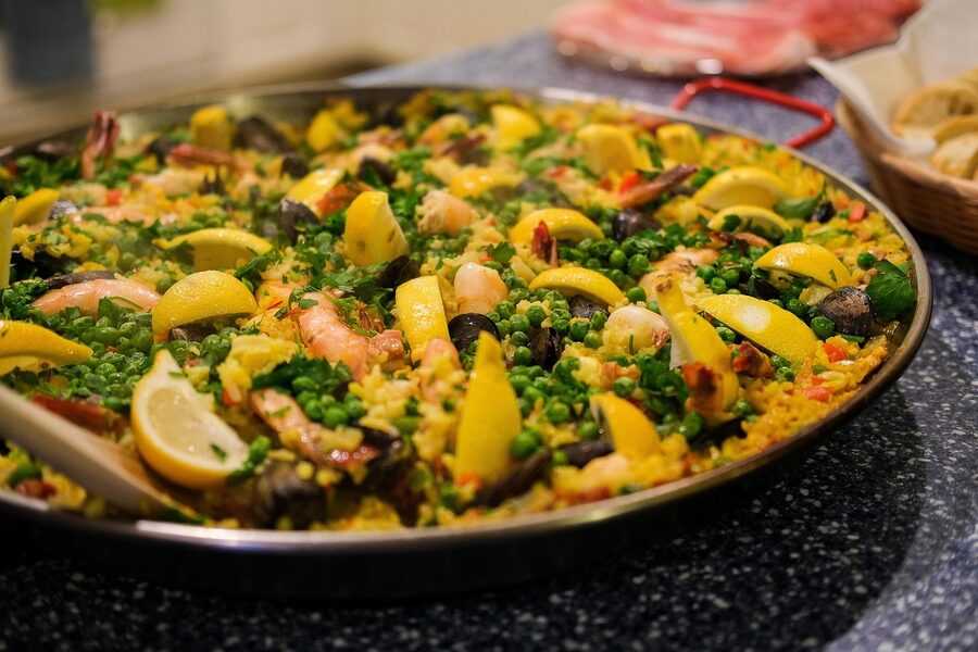 Traditional Spanish paella with seafood and saffron rice in a pan