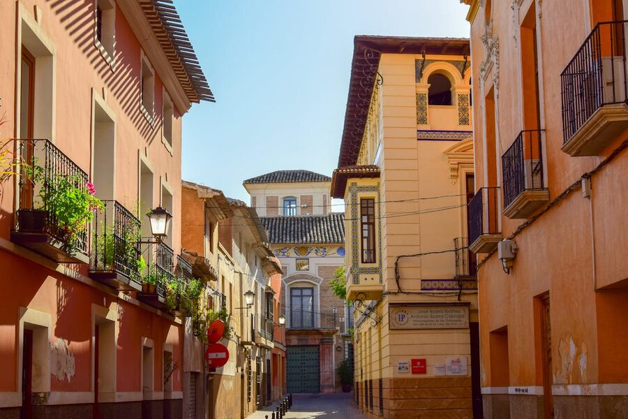 Street view in Mula Murcia Spain with colorful buildings and iron balconies