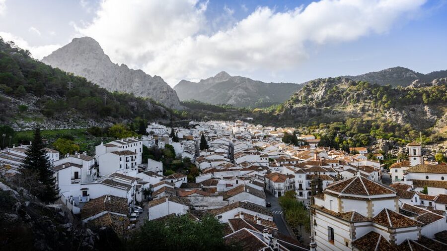 White Spanish village surrounded by mountains in a green landscape