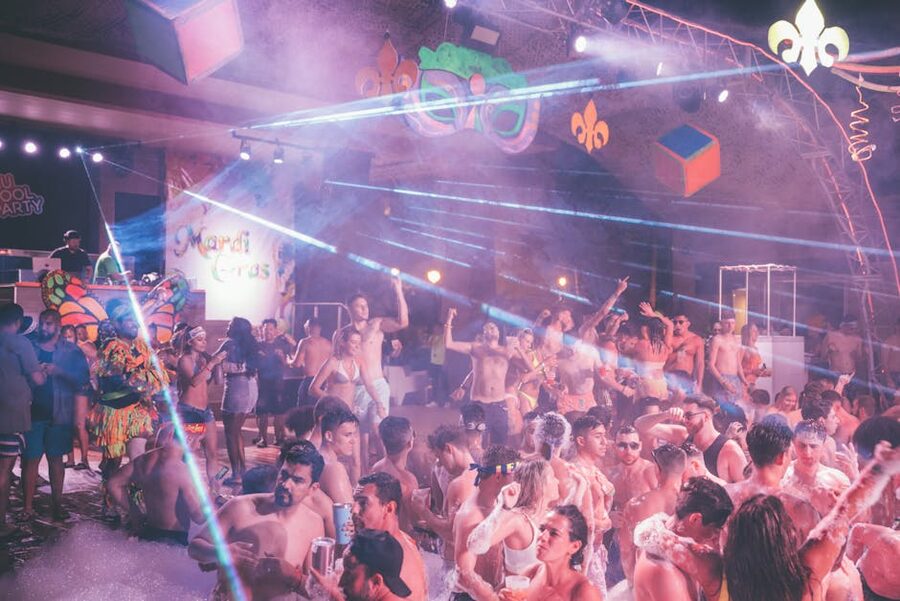 Indoor pool party with people enjoying drinks