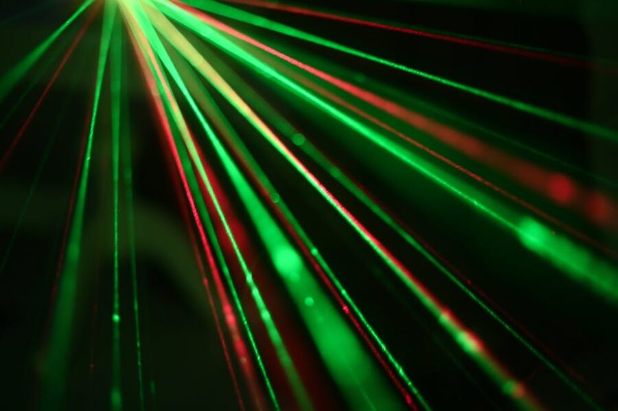 Red and green laser beams at night party