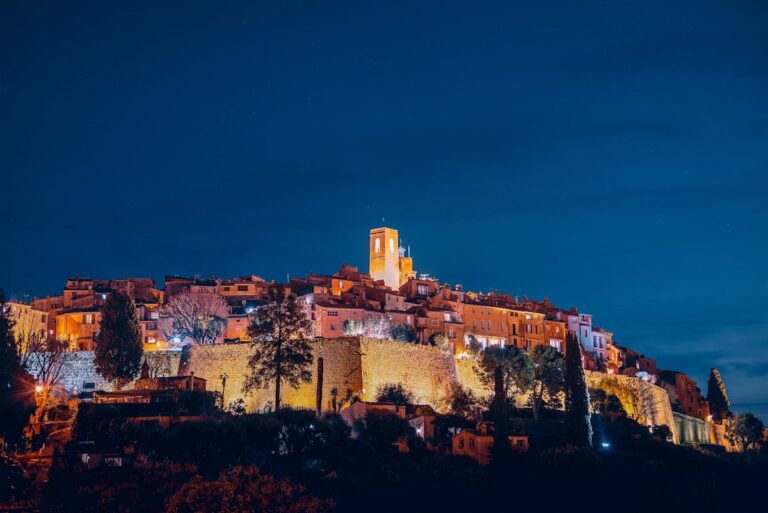 Saint-Paul-de-Vence medieval village with illuminated buildings and bell tower on hilltop at night