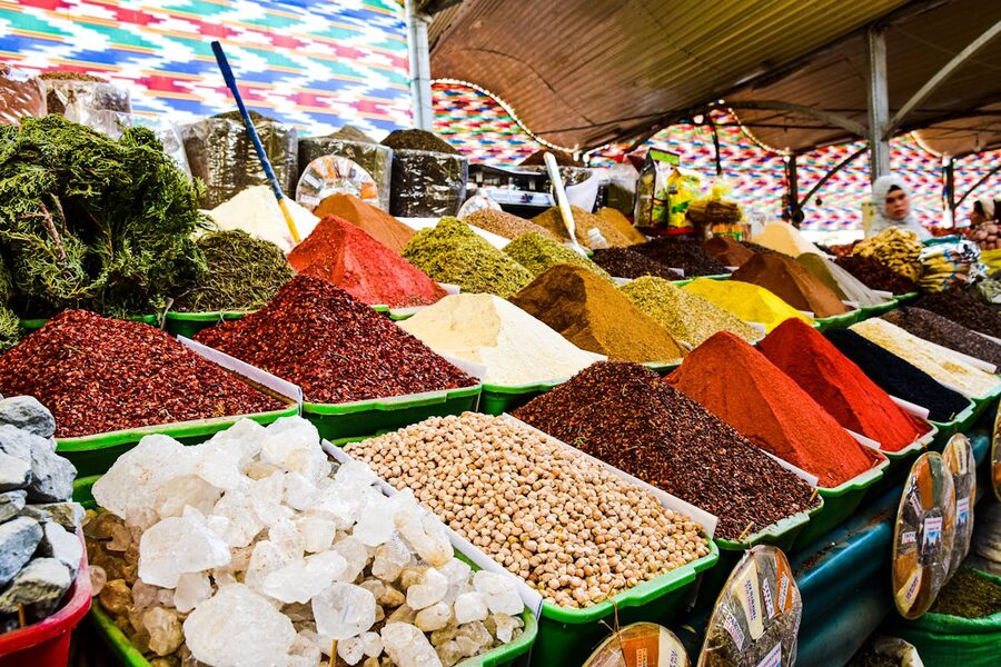 Vibrant display of ground spices in bins at a Mediterranean market stall
