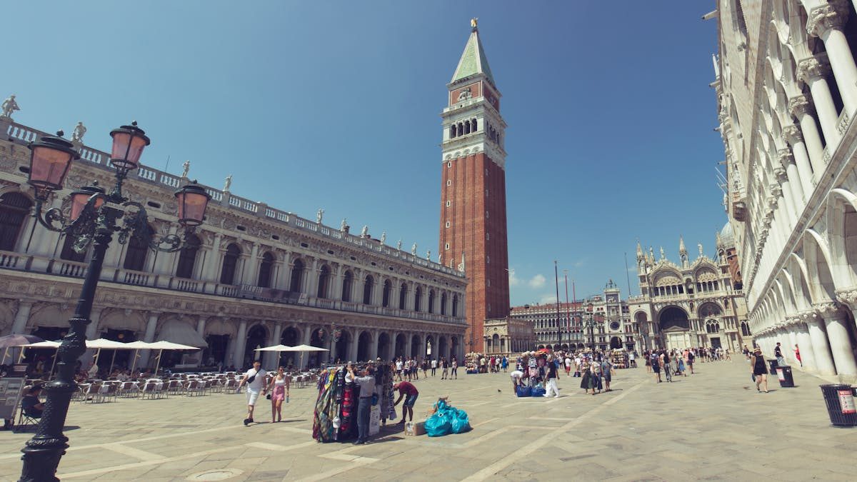 Piazza San Marco in Venice Italy with travelers and historic buildings