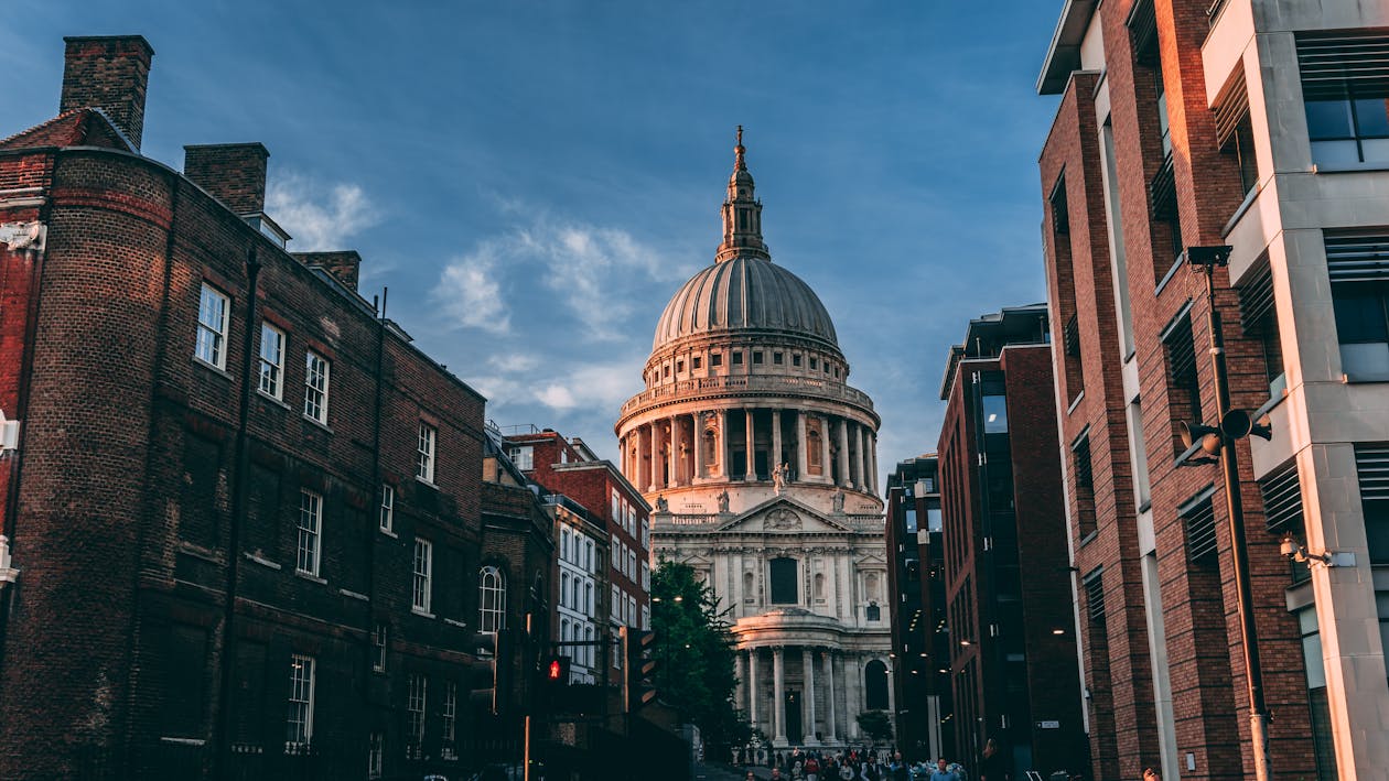 View of St Pauls Cathedral dome rising above surrounding buildings in London