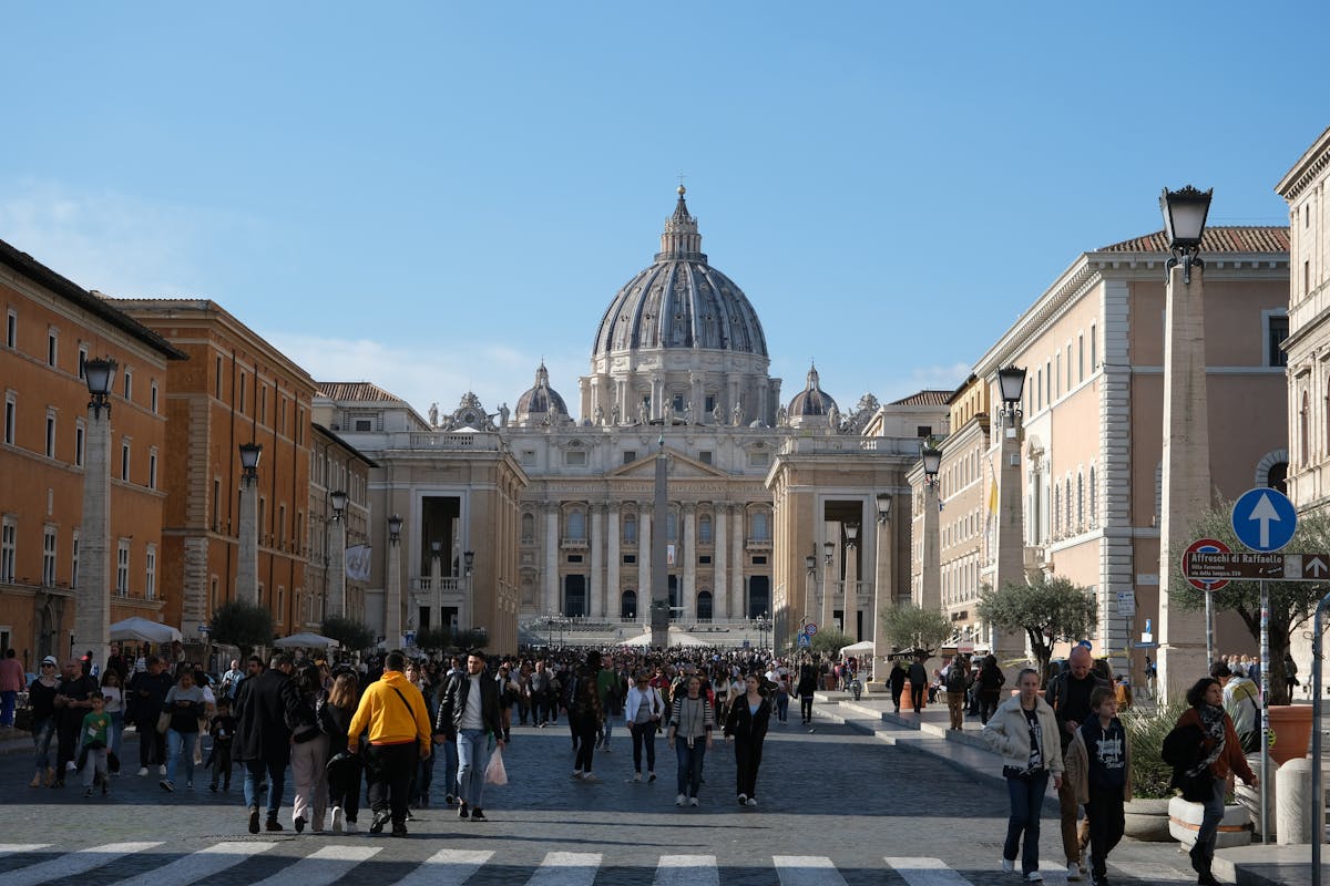 Large crowds of visitors gathered in front of St. Peters Basilica during a busy day