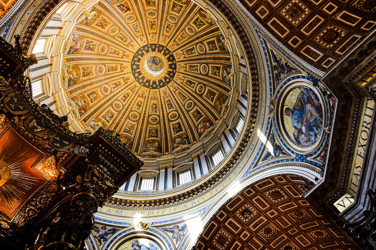 Looking up at the Renaissance frescoes and mosaics inside the dome of St. Peters Basilica
