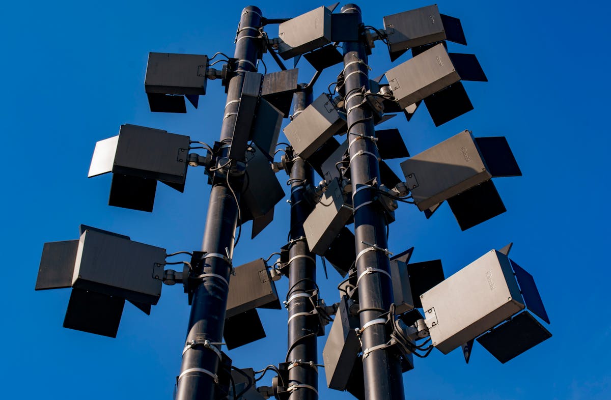 Stadium floodlights against clear blue sky