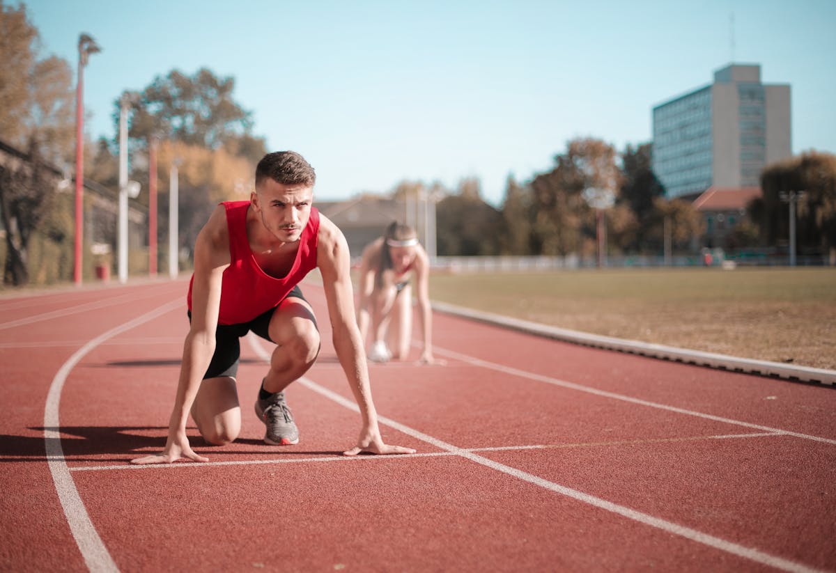Sprinters at starting position on athletics track