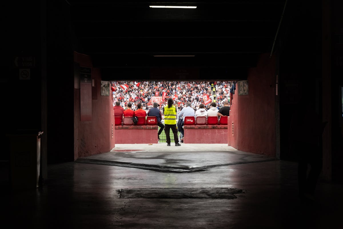 Stadium tunnel looking out toward the pitch and packed stands
