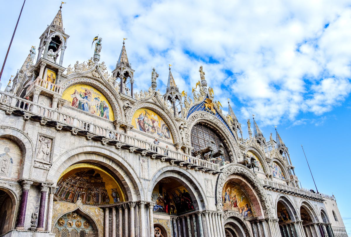 Low angle view of St Marks Basilica ornate facade against blue sky